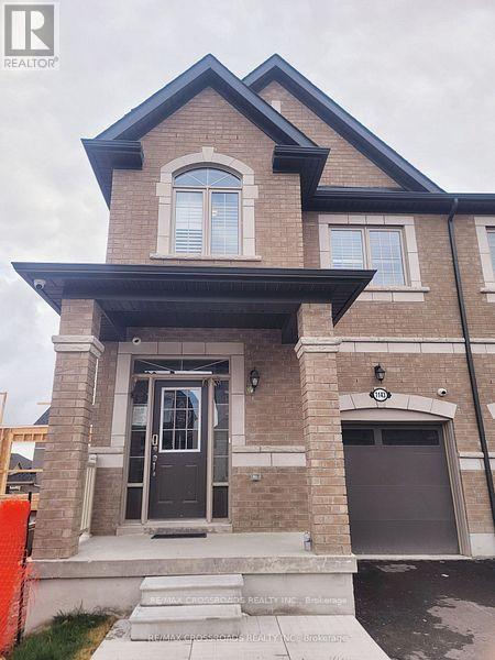 A house with a black door and windows is for sale.