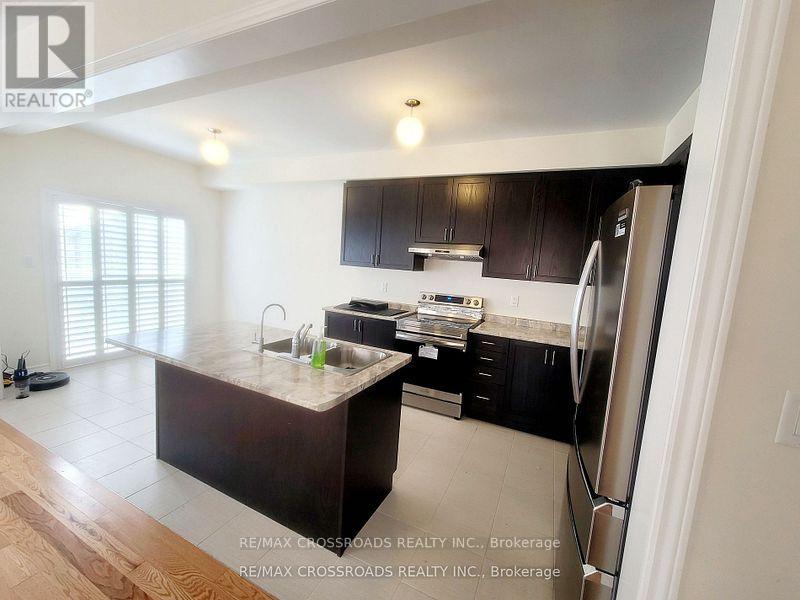 A kitchen with a refrigerator on the right side.