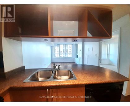 A kitchen with a sink and cabinets.