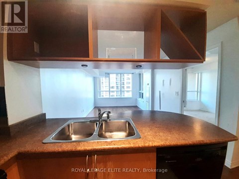 A kitchen with a sink and cabinets.