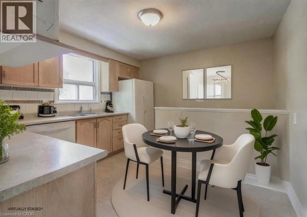 A kitchen with a table and chairs in the middle of the room.
