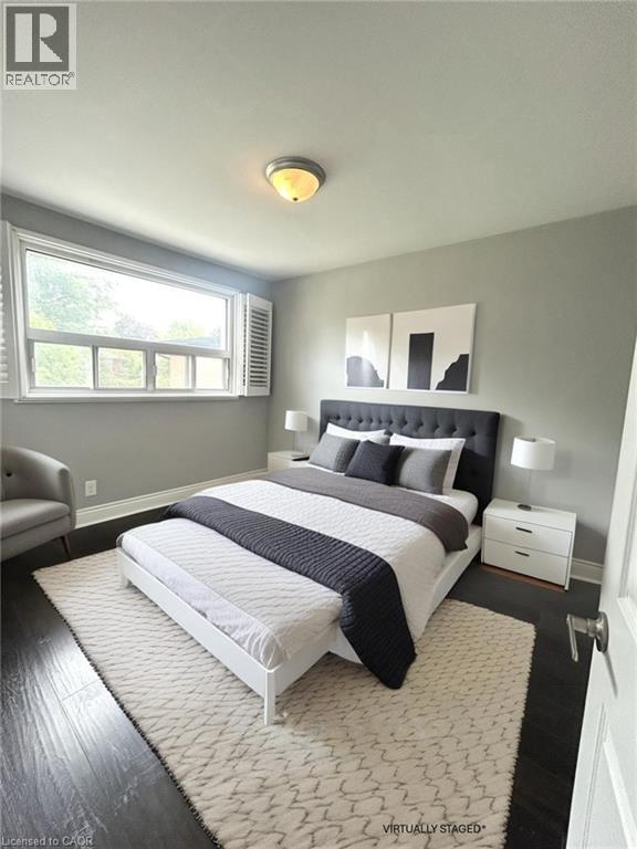 A bedroom with a large bed and a window.