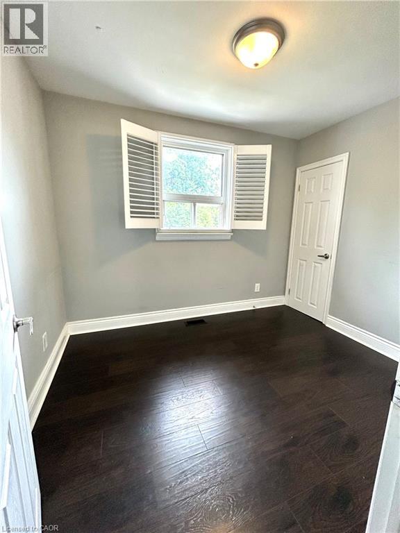 A room with a window and wooden floors.