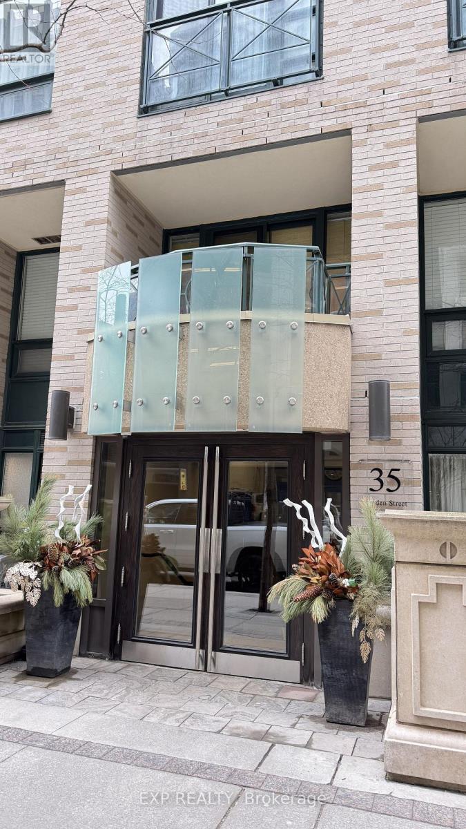 A building entrance with glass doors and a number 35 on the wall.