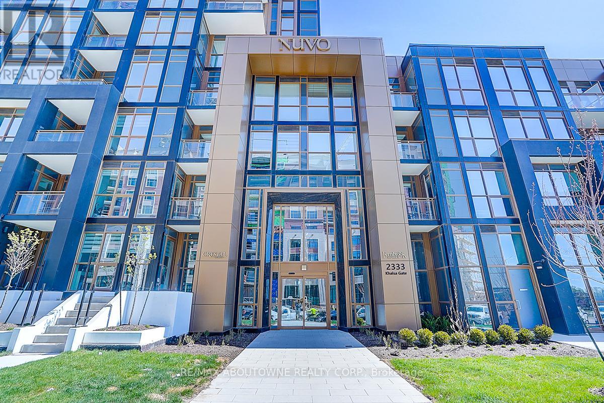 A modern building with a glass facade and a central entrance.