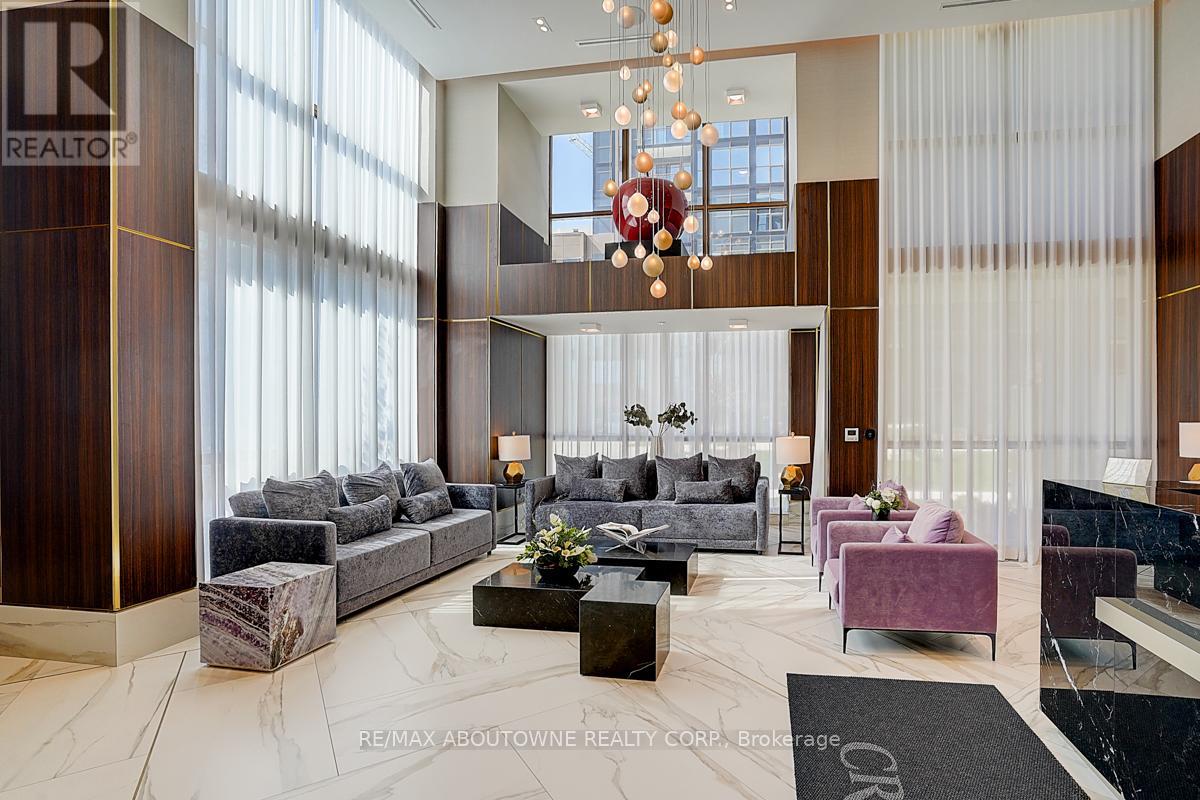 A large, modern living room with a chandelier and a variety of seating options.