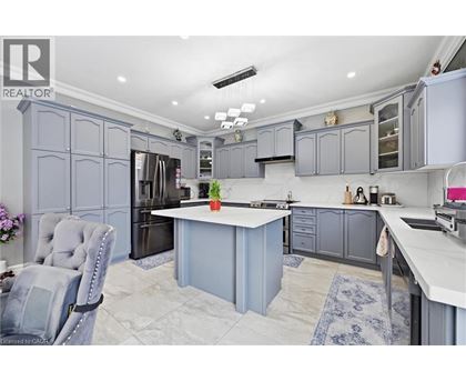 A kitchen with a grey chair and a white counter.