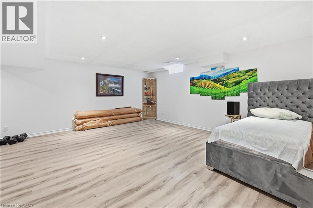 A bedroom with a large bed and a painting on the wall.
