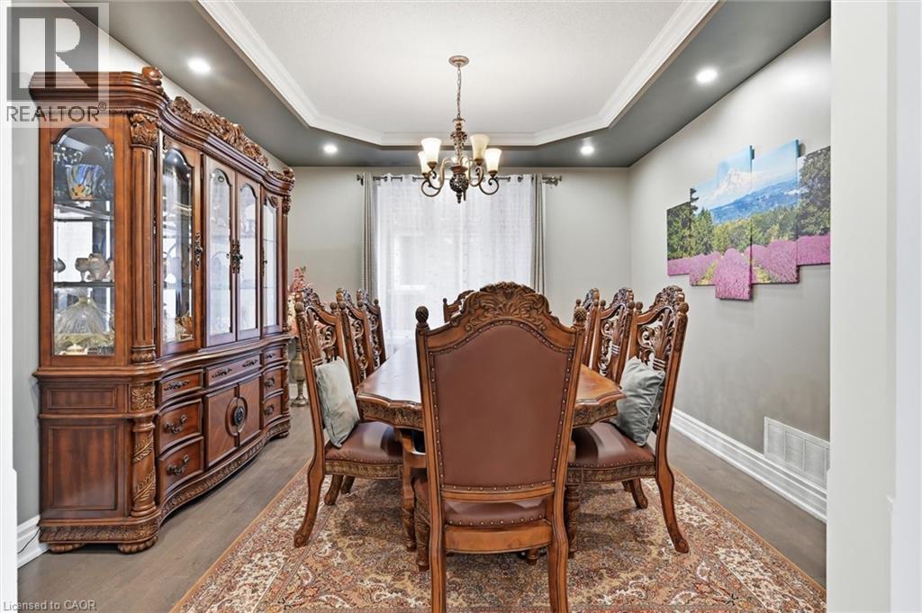 A dining room with a wooden table and chairs.