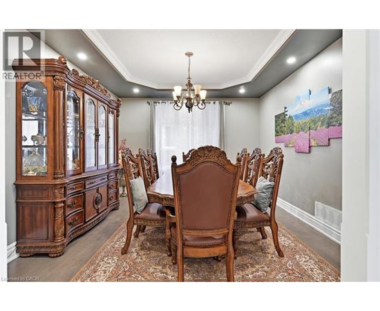 A dining room with a wooden table and chairs.