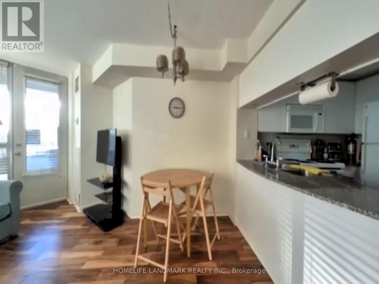 A kitchen area with a table and chairs.