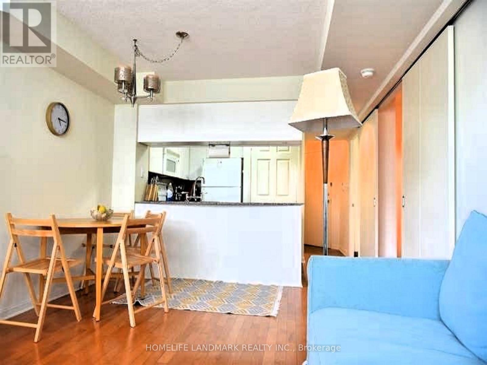 A living room with a dining table and chairs.
