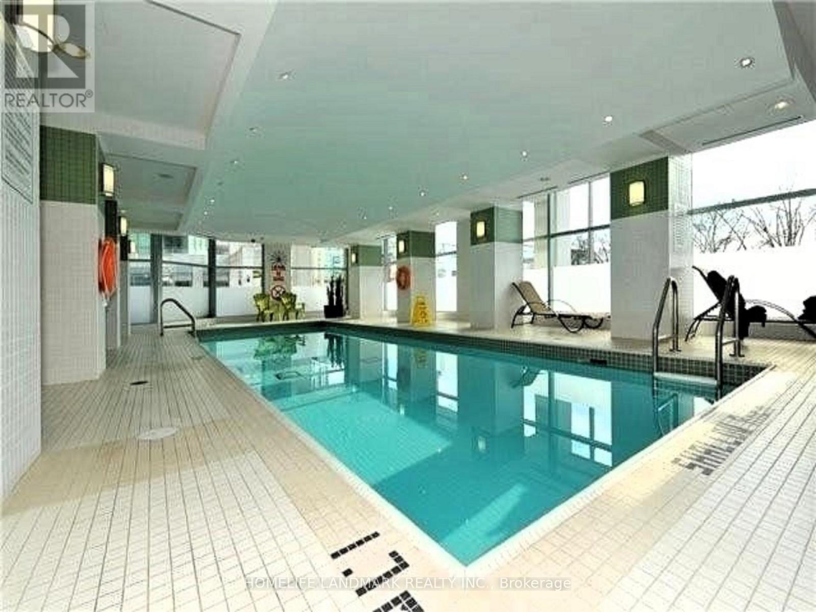 A large indoor swimming pool with a tiled floor.