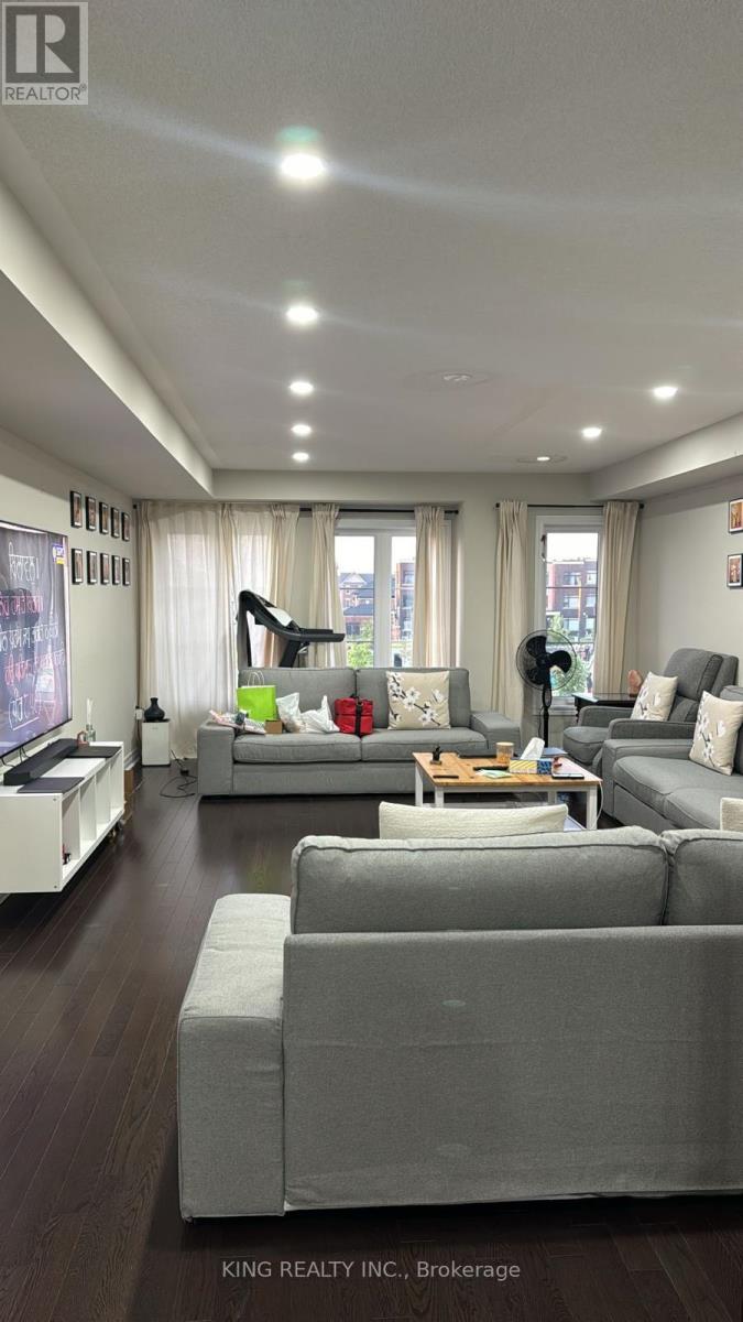 A spacious living room with grey couches and a coffee table.