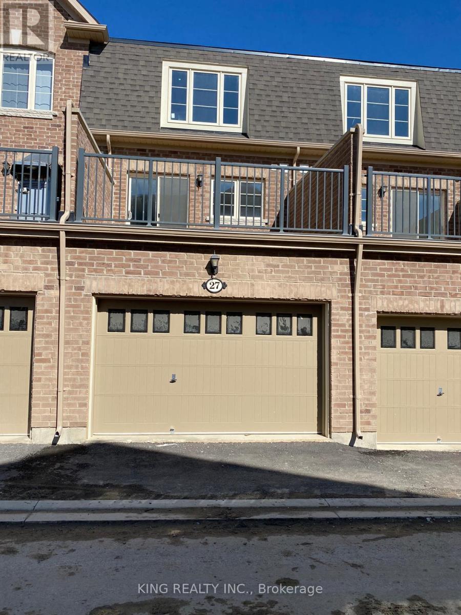 A building with a balcony and a garage door.