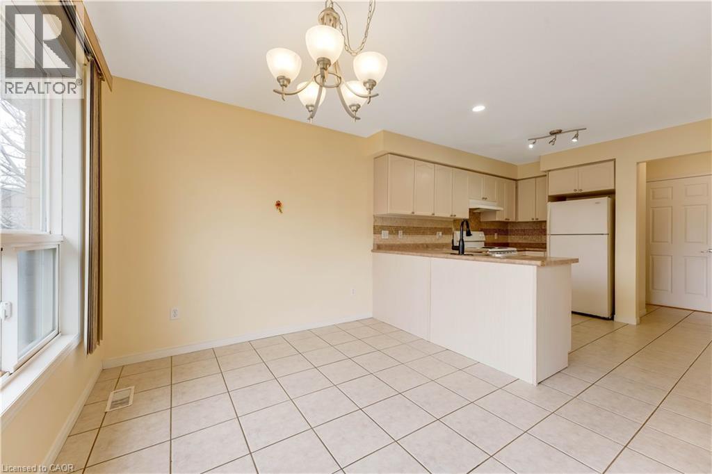 A spacious kitchen with a white countertop and cabinets.