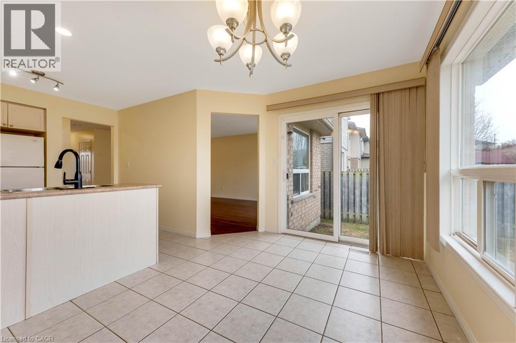 A spacious room with a chandelier and sliding glass doors.