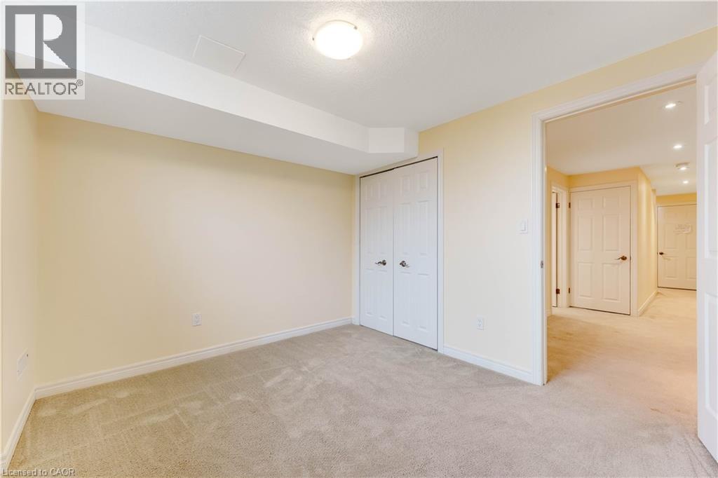A bedroom with a carpeted floor and white walls.