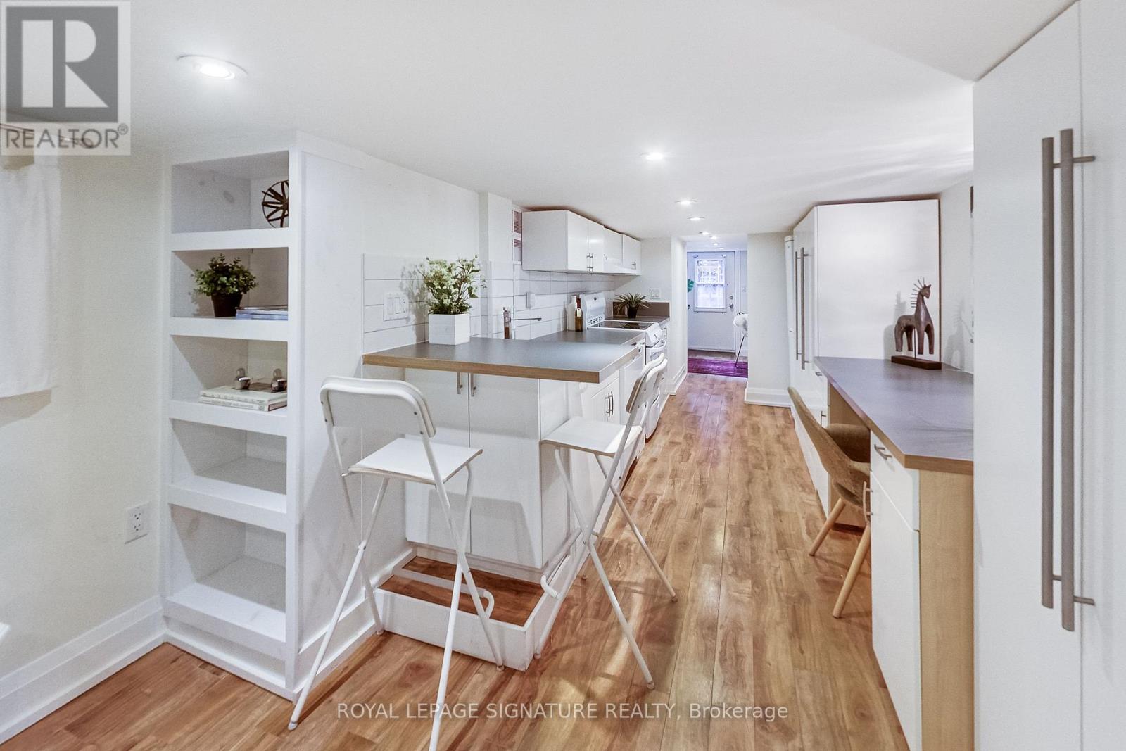 A white kitchen with a dining table and chairs.