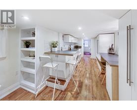 A white kitchen with a dining table and chairs.