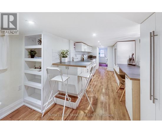 A white kitchen with a dining table and chairs.