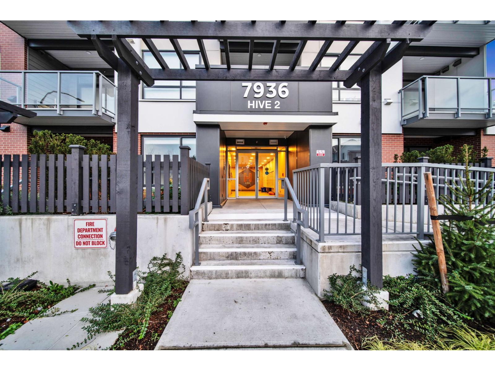 The front entrance to a building with a sign that reads 7936 HIVE 2.