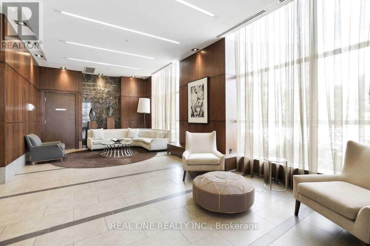 A spacious living room with a large window and a rug on the floor.