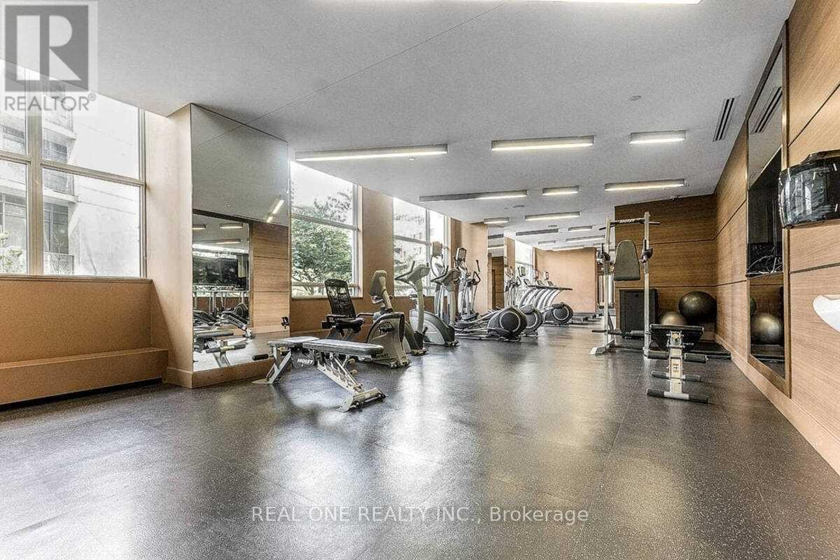 A gym with a variety of equipment including treadmills, weights, and exercise machines.
