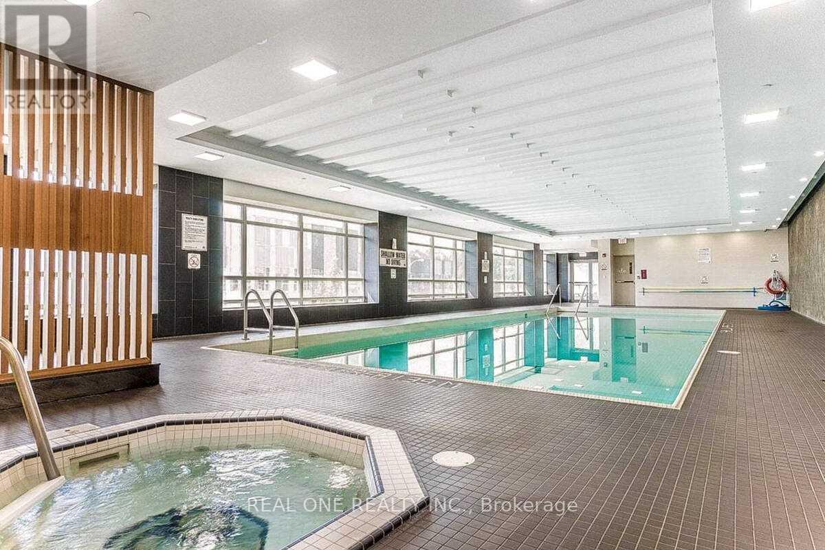 A large indoor swimming pool with a hot tub in the middle.