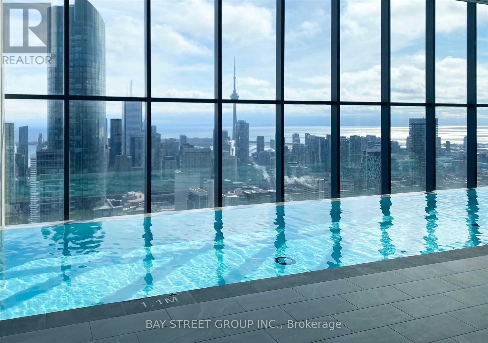 A swimming pool with a view of the cityscape.