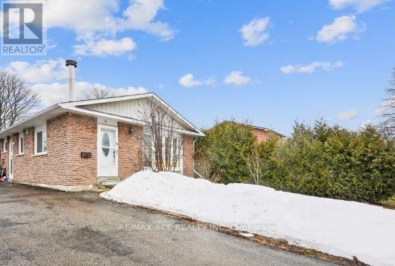 A house with a white door and a chimney is surrounded by snow.