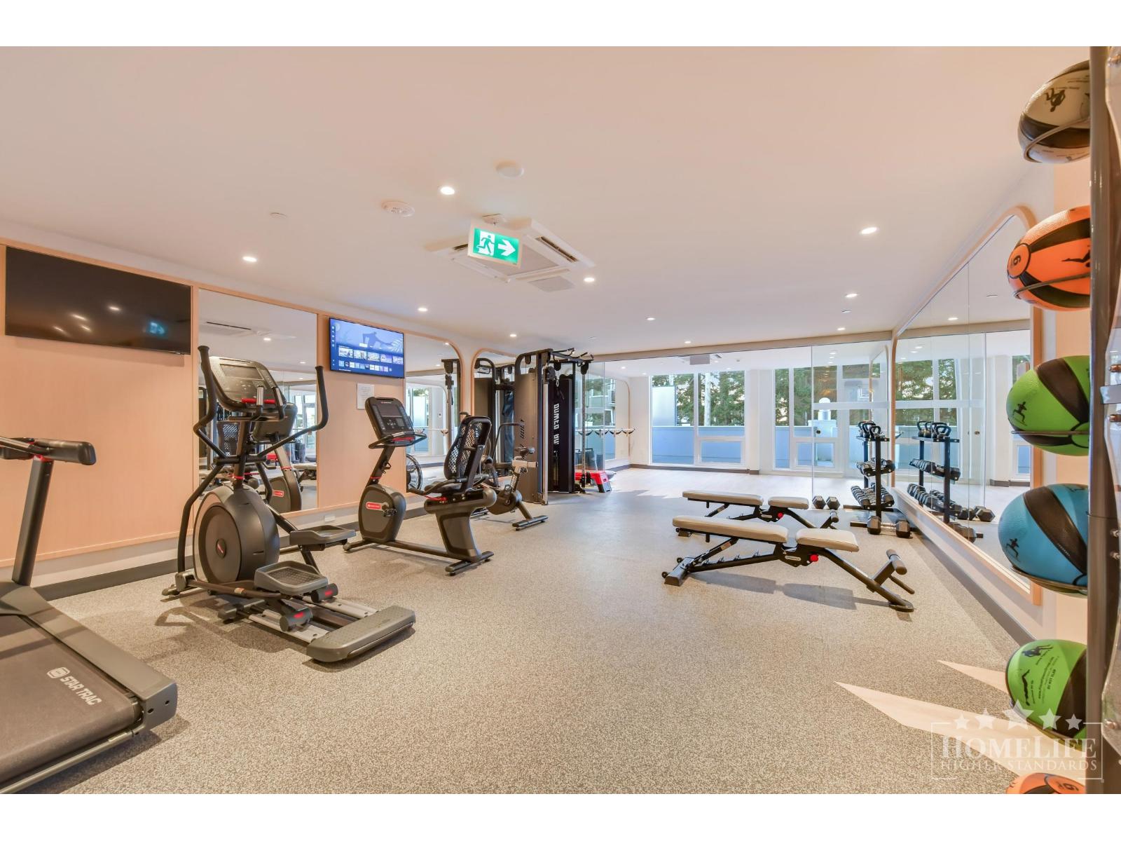 A gym with treadmills, exercise bikes, and other equipment.