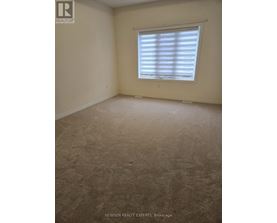 A room with a window covered by white blinds.