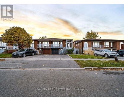 A real estate company's photo of a residential area with houses and cars.