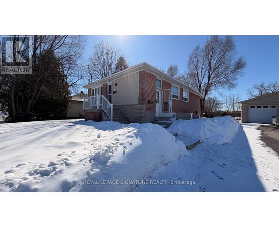 A house with a snow-covered ground in front of it.
