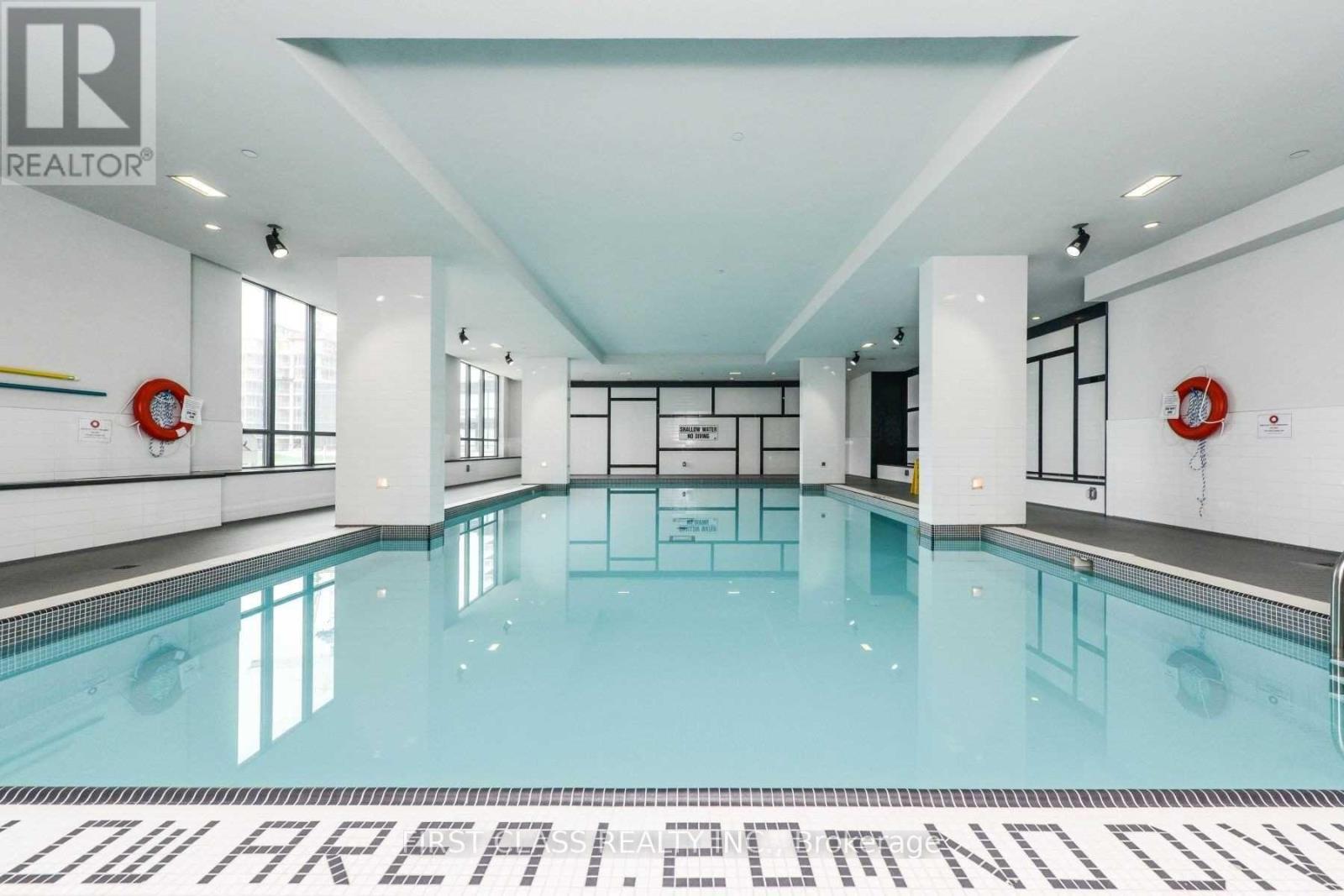 A large indoor swimming pool with a sign that reads "LOW AREA.COM".