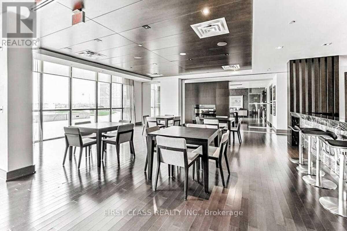 A dining room with a long table and chairs.