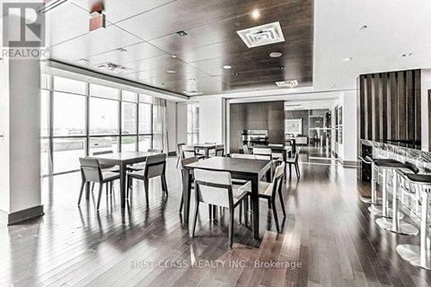 A dining room with a long table and chairs.