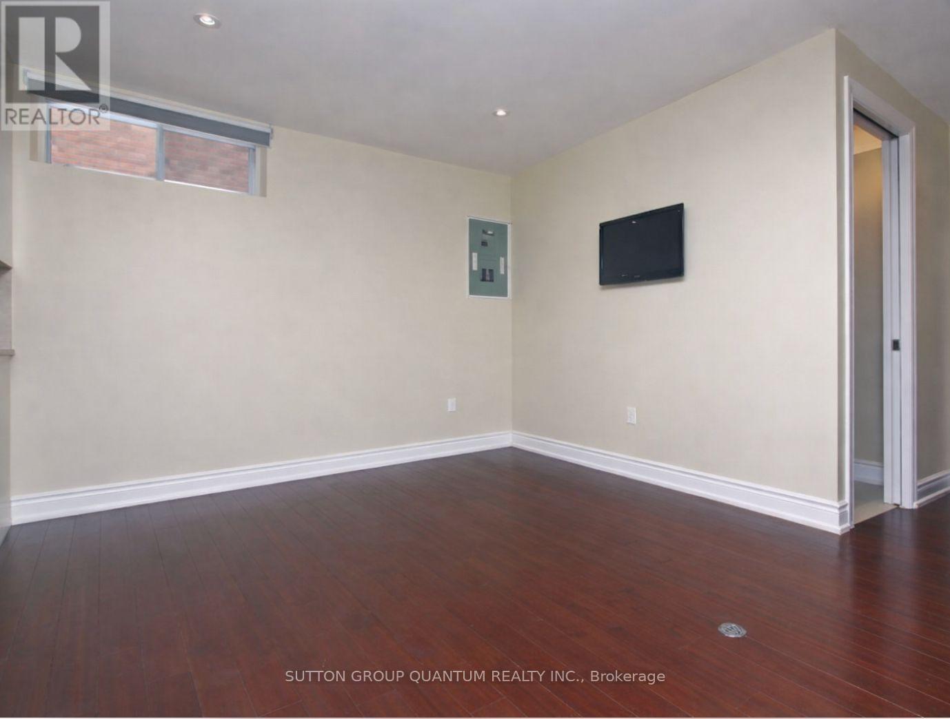 A room with a flat screen TV mounted on the wall.