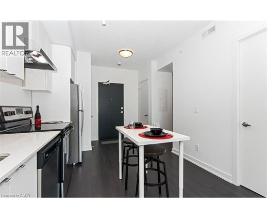 A modern kitchen with a dining table set for two.
