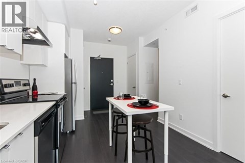 A modern kitchen with a dining table set for two.