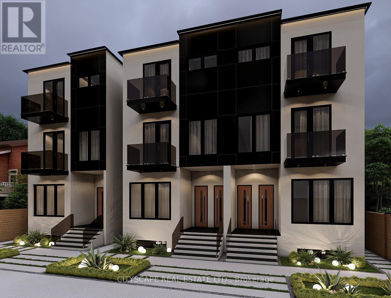 A modern two-story residential building with balconies and a front garden.