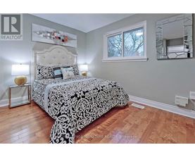 A bedroom with a large bed and a mirror on the wall.