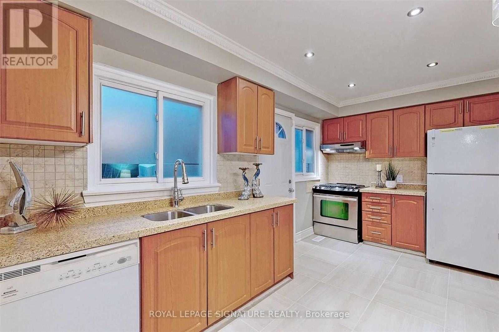A kitchen with wooden cabinets and white appliances.