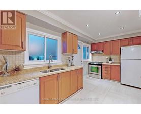 A kitchen with wooden cabinets and white appliances.