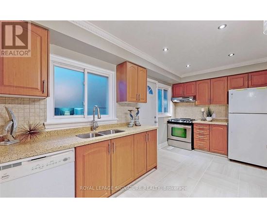 A kitchen with wooden cabinets and white appliances.
