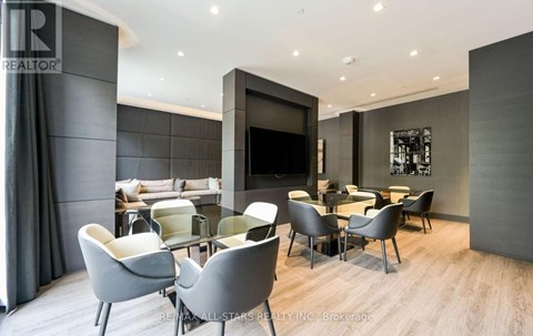A modern living room with grey chairs and a television.