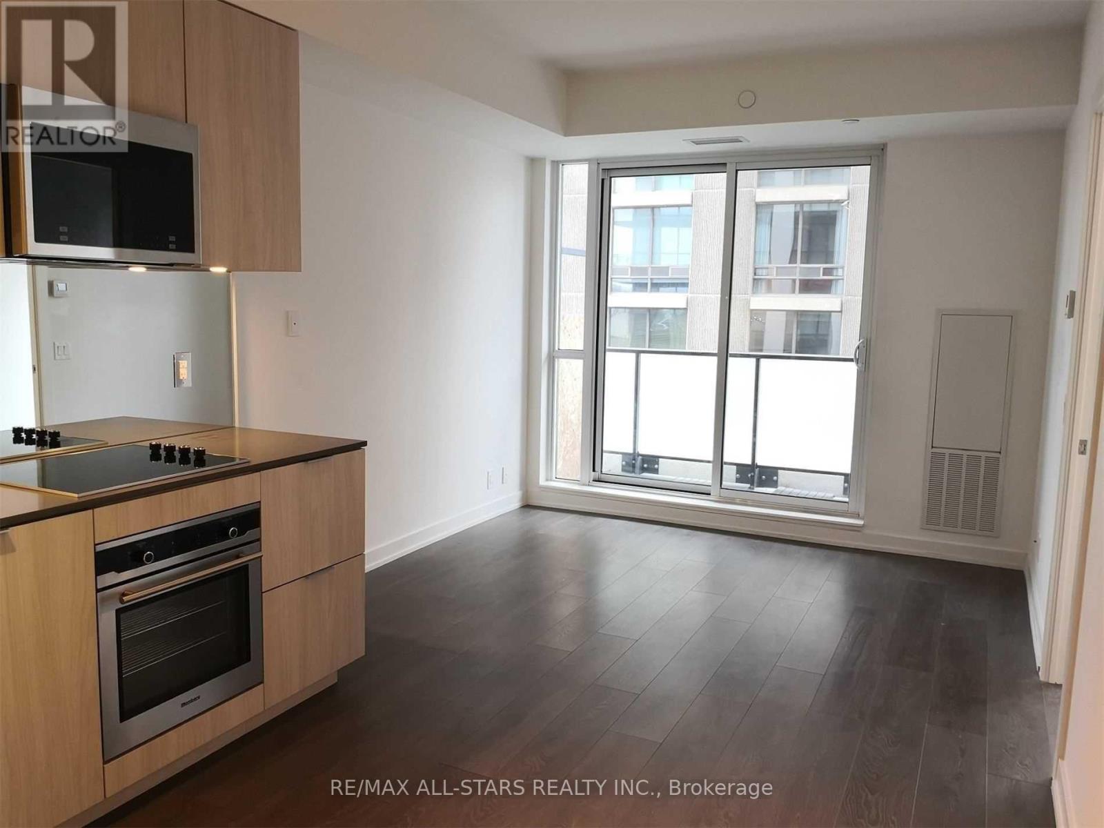 A kitchen with a stove top oven and microwave above it.