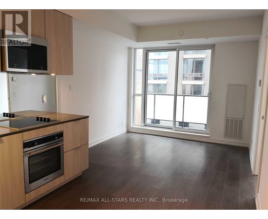 A kitchen with a stove top oven and microwave above it.