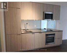 A modern kitchen with wooden cabinets and stainless steel appliances.